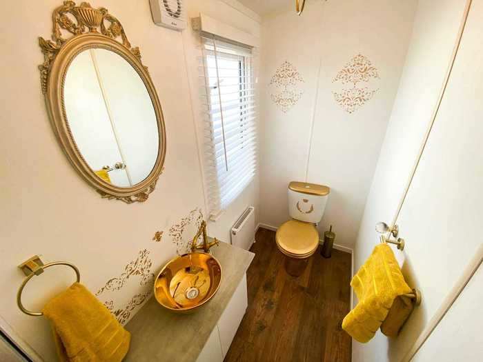 The second bathroom is also golden-themed.