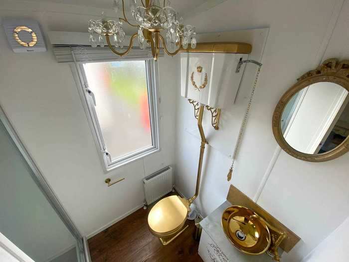 The master bathroom has a golden toilet.