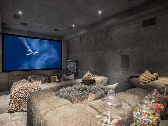 The home cinema is outfitted with comfortable-looking sofas and a popcorn machine.