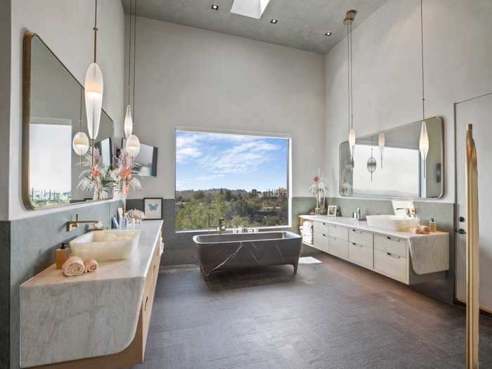 The master bathroom has a marble Teuco tub, onyx sinks ...