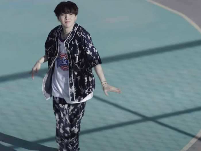 Suga is wearing a Tune Squad jersey from "Space Jam."