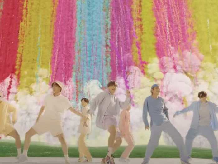 The music video is full of vibrant pastel colors, a recurring motif for the group.