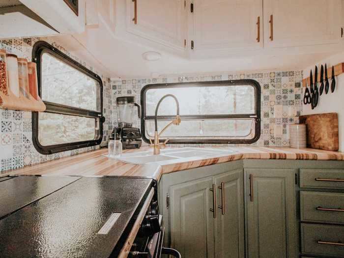 The kitchen features both green and white cabinetry.