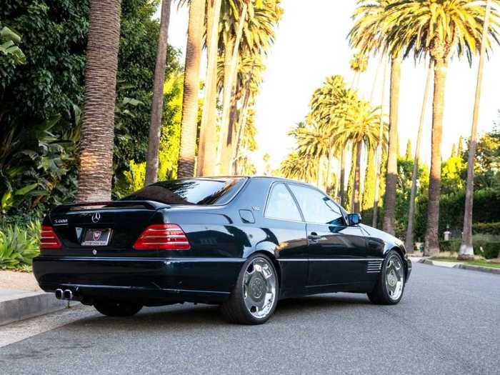 The car is finished in a metallic navy blue ...