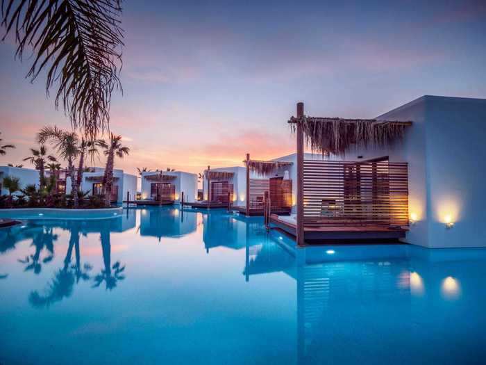 The Grand overwater bungalows are secluded, and the standard ones (below) are divided by screens for privacy.