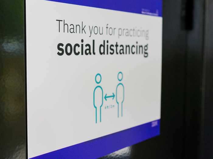 There are signs, as well as stickers on the floor, to remind people to social distance in communal areas, such as inside bathrooms.