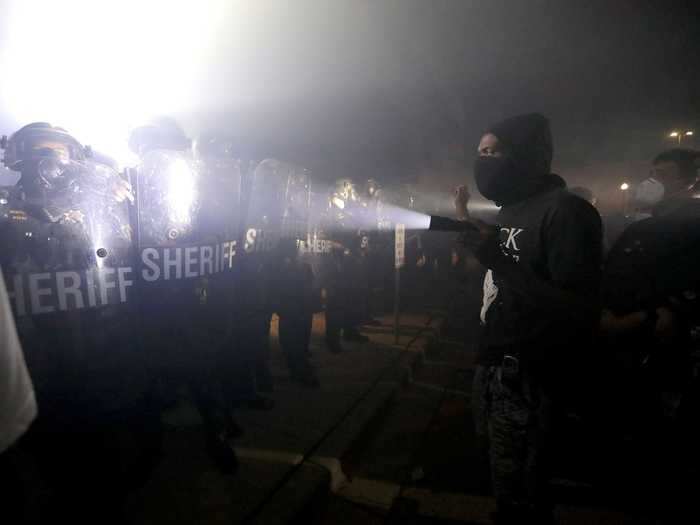 Demonstrators faced off with law enforcement. As protesters marched near a local police station, they received pushback from officers.