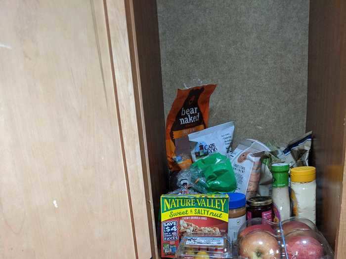 I think this compartment was meant for clothes since it had a closet rod (though no hangers), but since it was located between the fridge and kitchen sink it made more sense to us as a pantry.