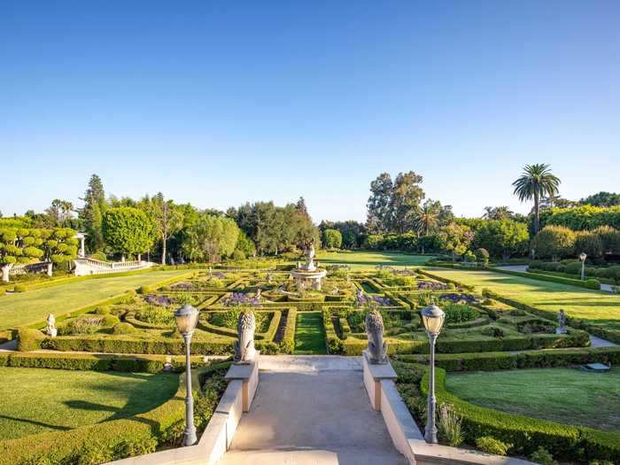 From the foyer, a path leads to a maze-like French garden with a fountain at its center.