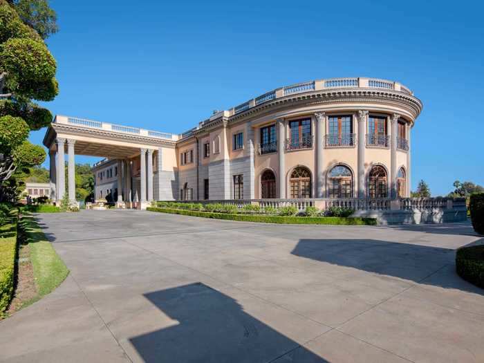 The front of the home boasts grandiose porte-cochère, or covered entryway.