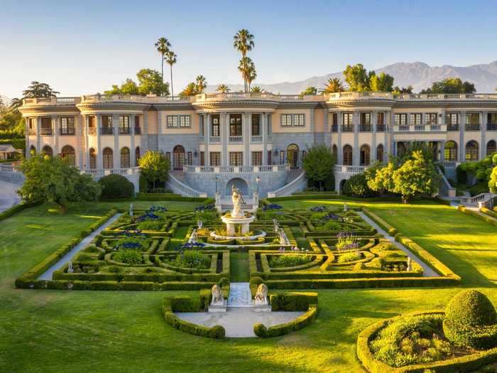 Designed in the Beaux-Arts style, the main residence features a low-lying roof, dramatic columns, and four wings.