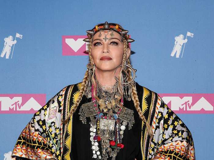 Madonna wore a printed tunic and silver-horned headpiece with layered necklaces.