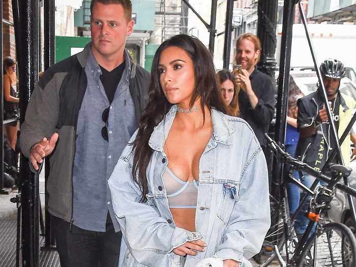 While out in NYC in 2016, Kardashian West was photographed in a sheer bra, an oversized denim jacket, a skirt, and clear Yeezy boots that reached her thighs.