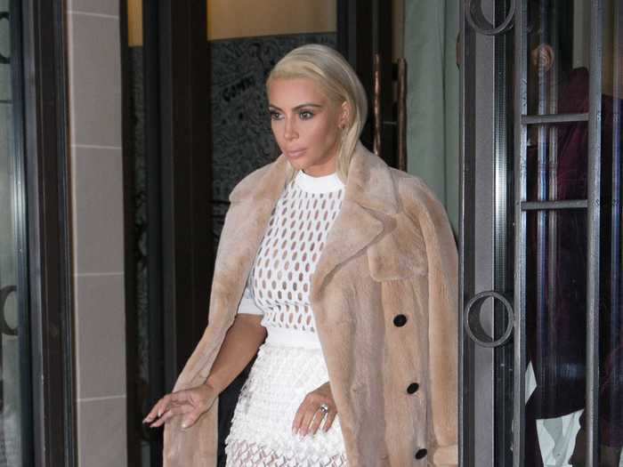 During the same Paris trip, she wore a netted white dress with an oversized camel coat.