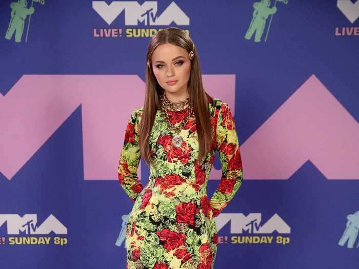 Joey King wore a floral Versace dress with red heels.