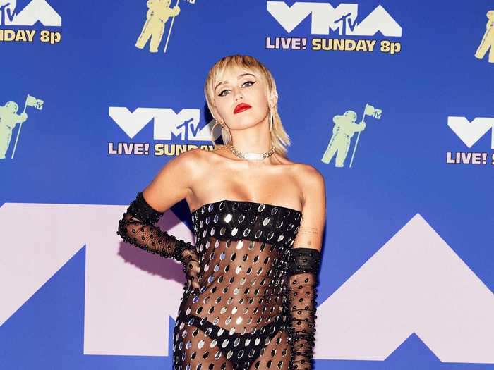 Miley Cyrus left little to the imagination in this see-through Mugler midi dress with matching gloves and simple black sandals.