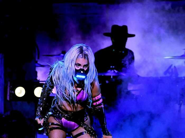 Gaga kept the same LED mask on but changed her outfit to a purple bra top and matching underwear with lace-up black boots to perform "Rain On Me" with Ariana Grande.