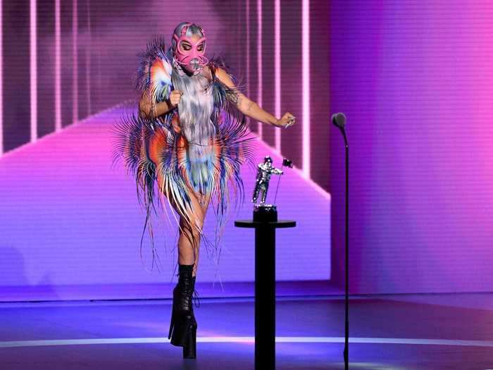 Lady Gaga accepted the best collaboration award in an Iris van Herpen dress with a pink mask by Cecilio Castrillo and Pleaser boots.