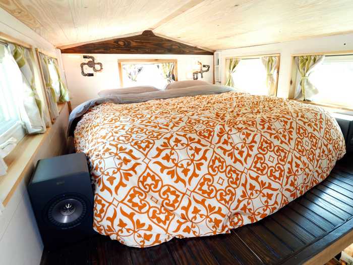 The master bedroom is a cozy loft above the kitchen.