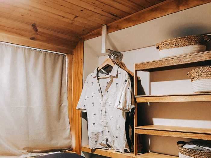 A cozy master bedroom sits at the back of the bus.