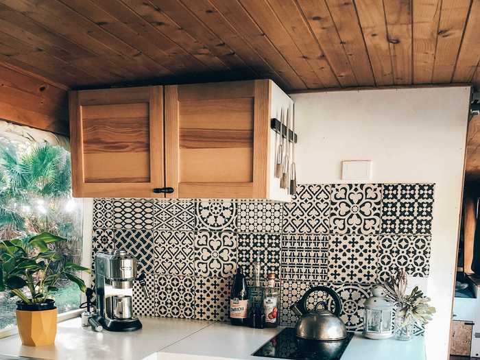 The calming color scheme continues into the kitchen, which has a freezer, a sink, and a stovetop.