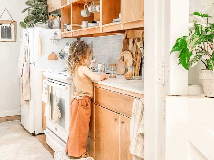 The kitchen features an oven, stove, full-size refrigerator, and a dishwasher.