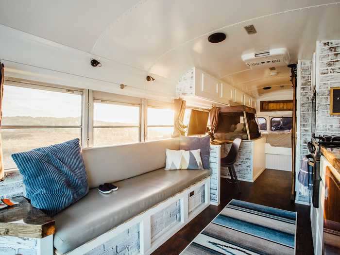 The living room and kitchen sit at the front of the bus, and safety features are built into its very structure.