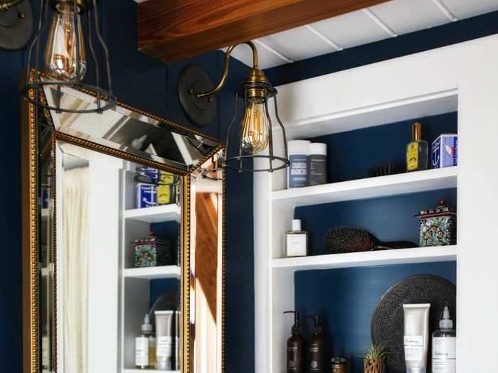 The bathroom was made with built-in open shelving storage to keep it organized.