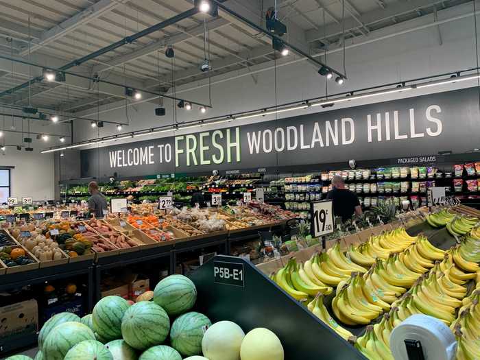 The fresh produce department carries a range of fruits and vegetables in open bins.