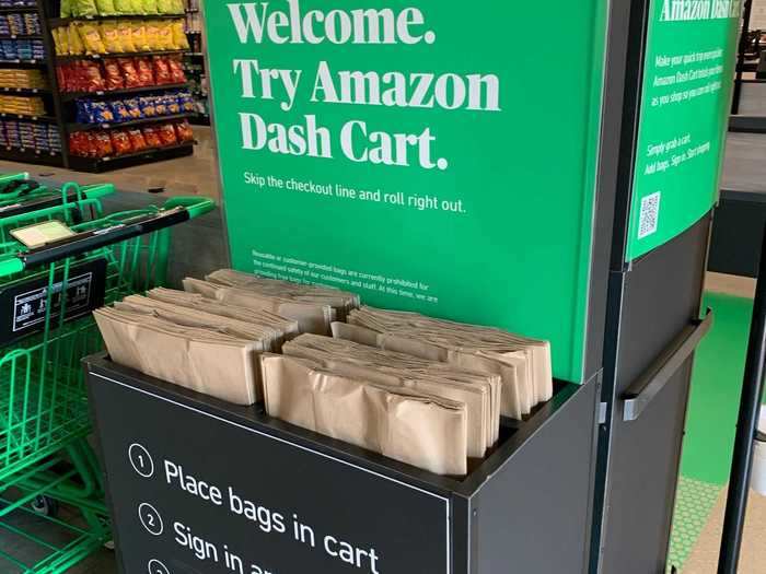 At the entrance inside the store, a kiosk invites customers to try Amazon