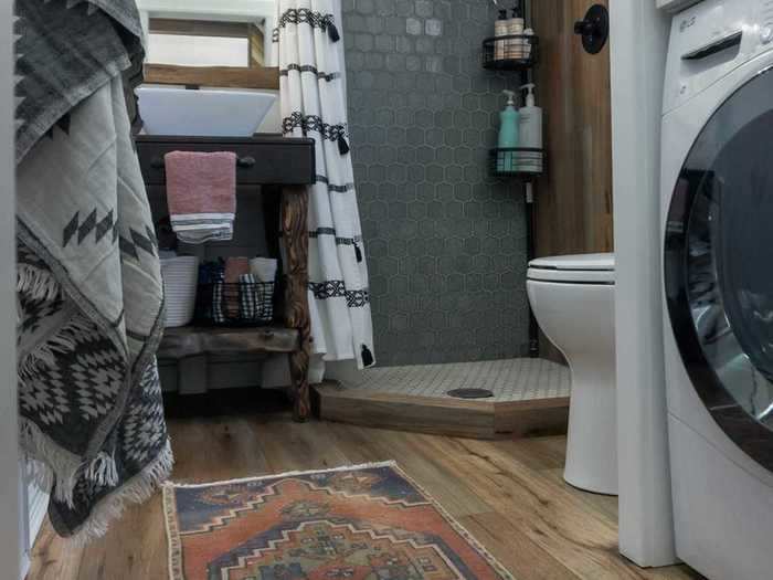 So, they created a pull out wall separating the washer and dryer from the toilet area. It houses a full-size changing mirror on the back side, while keeping the space tight.