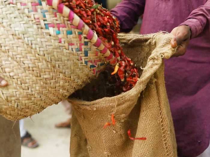 Saleem has been working for decades at the wholesale market, where farmers bring in their harvests and workers pack it into sacks by hand. Each bag holds nearly 28 kilograms of peppers and fetches about 15,000 rupees, the equivalent of $90.