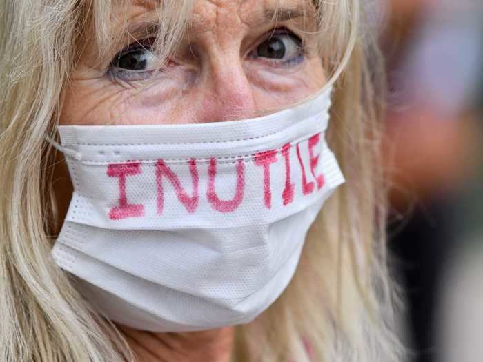 Not everyone in France is keen on the new mask mandates. This woman is protesting by writing the word "useless" in French on her mask. But, she