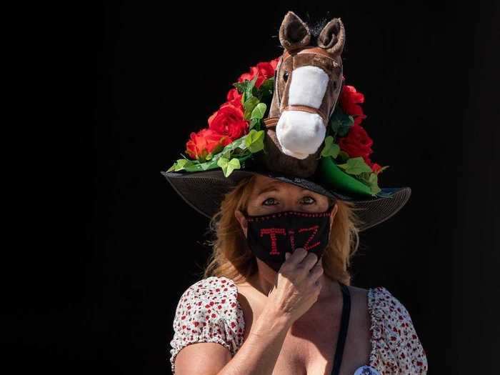 Others used their hat and face mask combination to show their support for contestants, such as this attendee, who