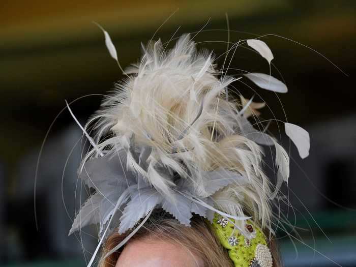 Another attendee coordinated their eye-catching, feather-clad hat with an ornate, pearl-covered mask.