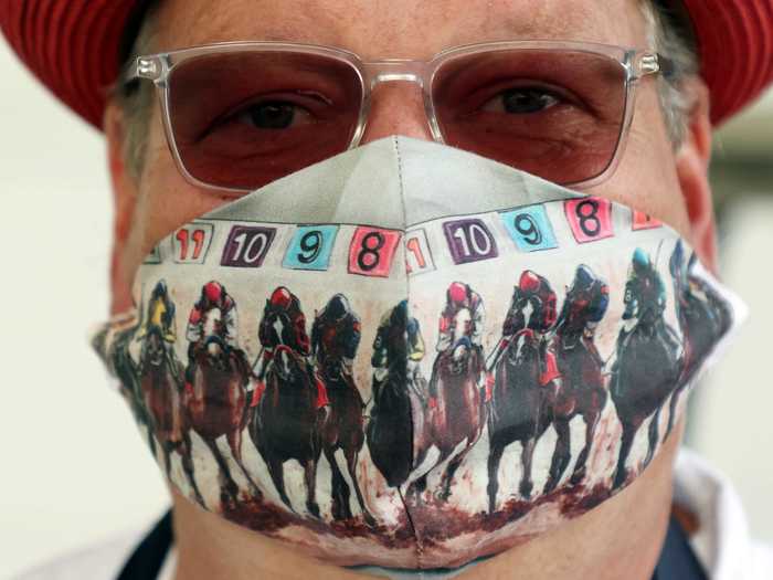 Some horse trainers, track workers, and spectators showed up in Derby-themed face masks.