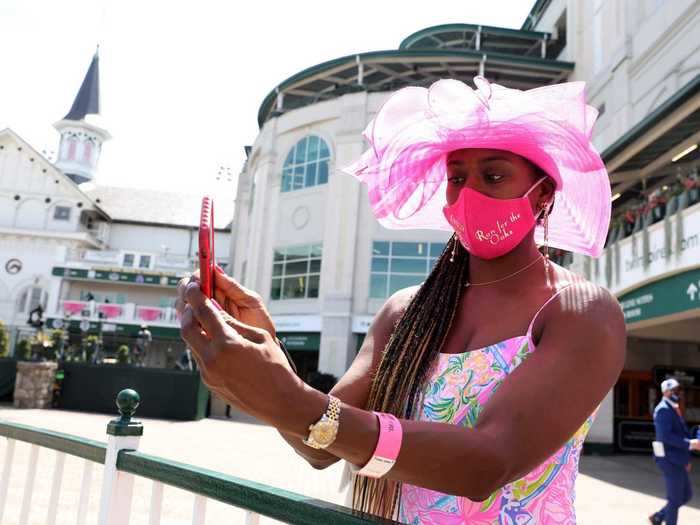 Some people gathered at Churchill Downs on Friday, dressed in pink for Kentucky Oaks Day, which marks the racing of female horses.