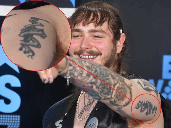 He also has a tattoo of a snake coiled around a rifle.