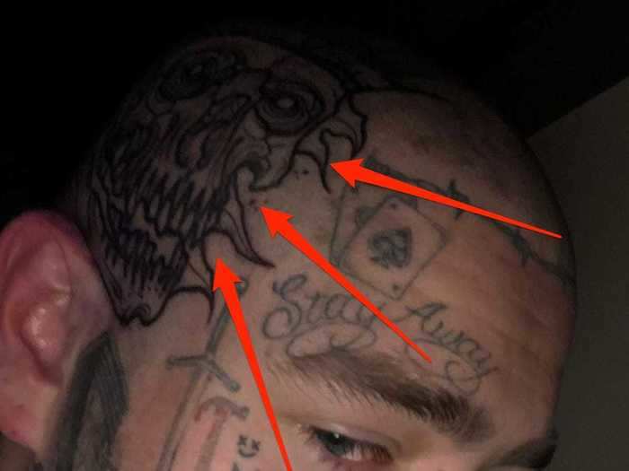 The musician has a tattoo of a skull on the side of his head.