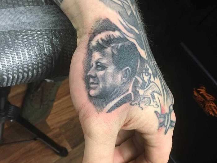 He has a portrait of John F. Kennedy, the 35th U.S. president, on the side of his hand.