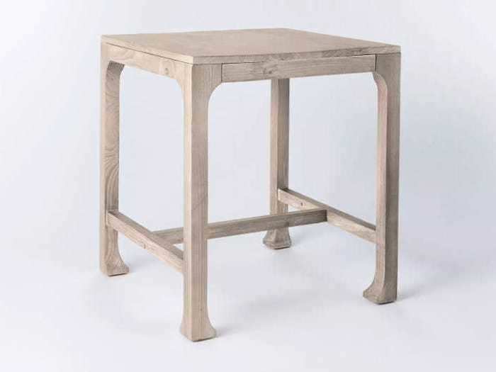 Add more surfaces to your living room with this natural-wood-finished end table.