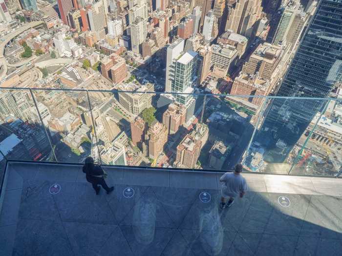 The outdoor deck features angled glass walls that make you feel like you are leaning over the city.