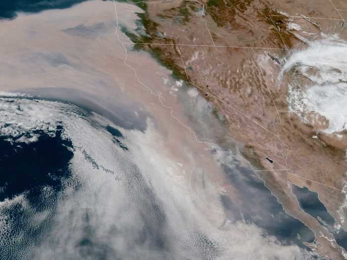 A satellite image taken Wednesday shows the smoke blanketing the coast as well as a large swath of the Pacific Ocean.