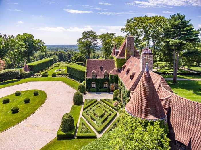 The castle-like home was influenced by English and French design, with turrets, Holland Brick, and granite covered in ivy.