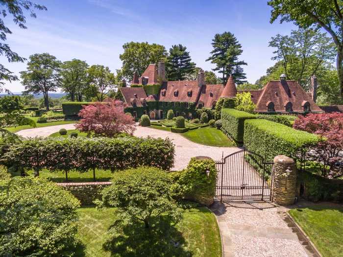 The 81-year-old home sprawls over 13,344 square feet and is surrounded by landscaped gardens and hedges.