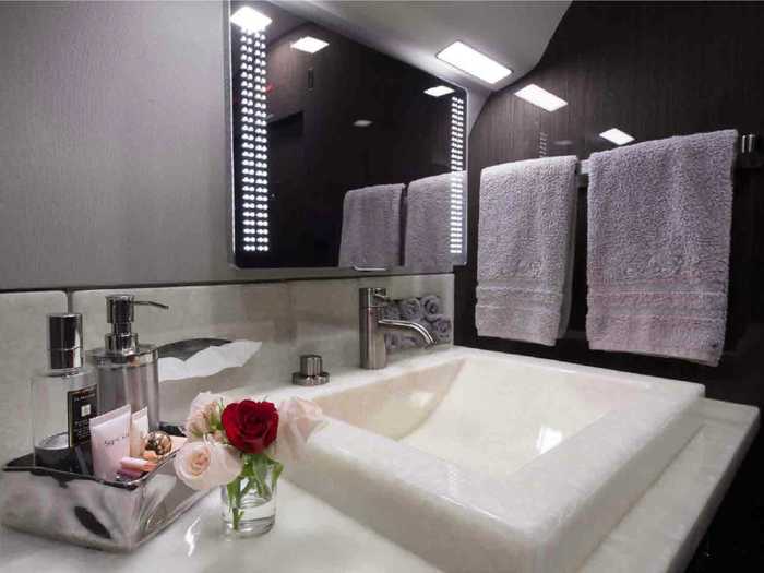 The master bathroom located behind the main stateroom is the largest and features a full sink and toilet.