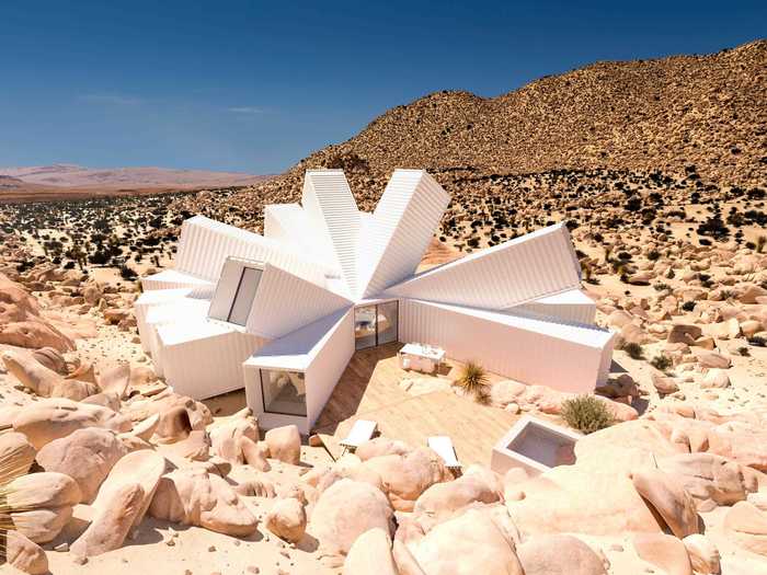 Consisting of 21 splayed shipping containers, the home resembles an exploding star.