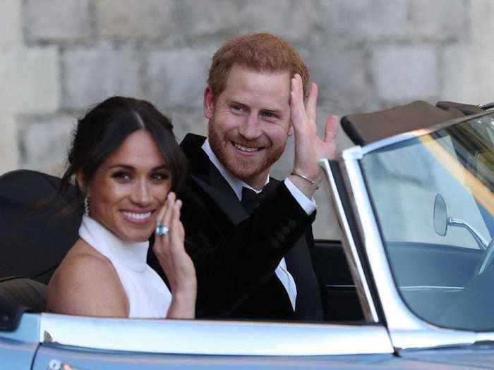 AGE 33: The newlyweds wave as they leave Windsor Castle after their wedding on May 19, 2018 to attend an evening reception at Frogmore House, hosted by the Prince of Wales.