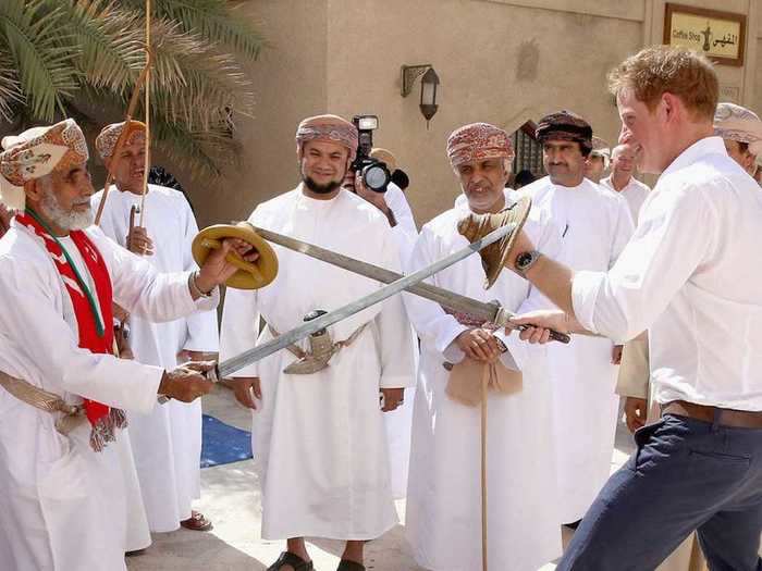 AGE 30: Harry is presented with a sword and shield as he meets traditional Omani Dancers during a visit to Oman in November 2014.