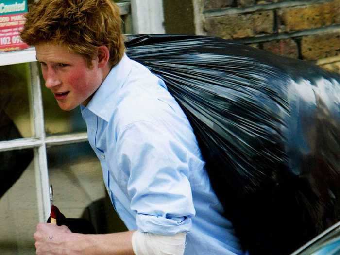 AGE 18: Prince Harry carries a suit and a bin bag full of belongings as he leaves Eton College on June 12, 2003.